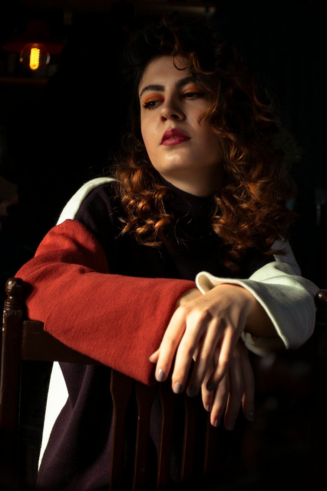 Studio portrait of a young woman with curly hair